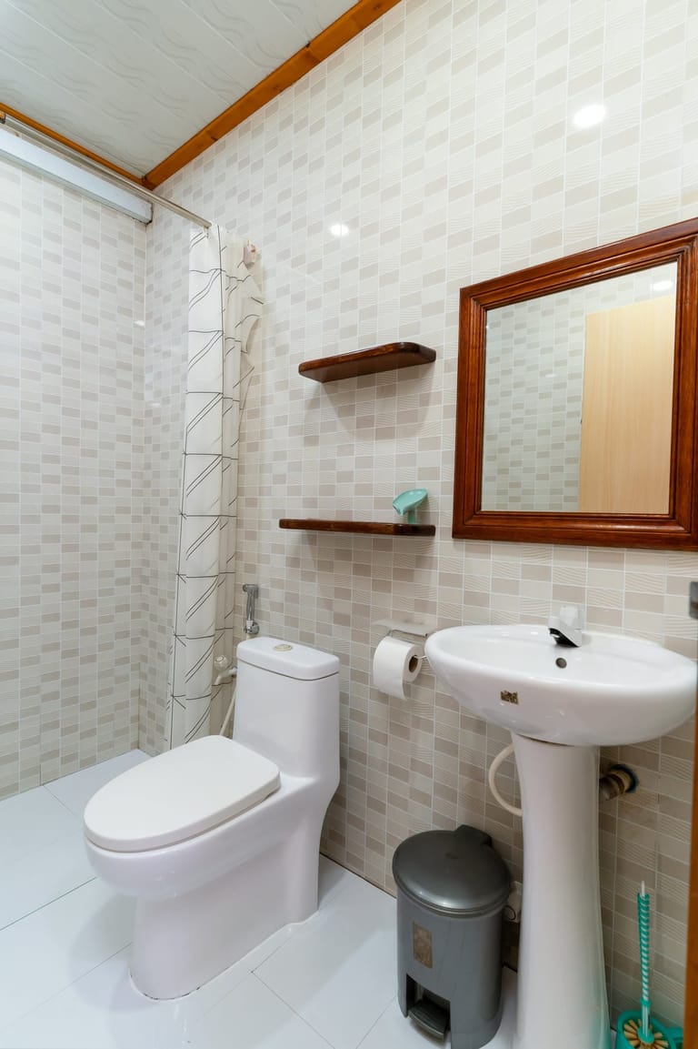 Bathroom 2: full view with beige tiles — two separate bathrooms in the home