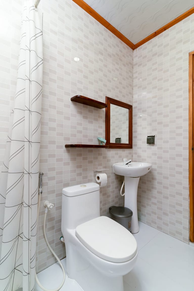 Bathroom 1: full view with white tiles, shower, toilet and sink