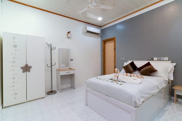 Bedroom with welcome towel art — the host prepares every room for arrival
