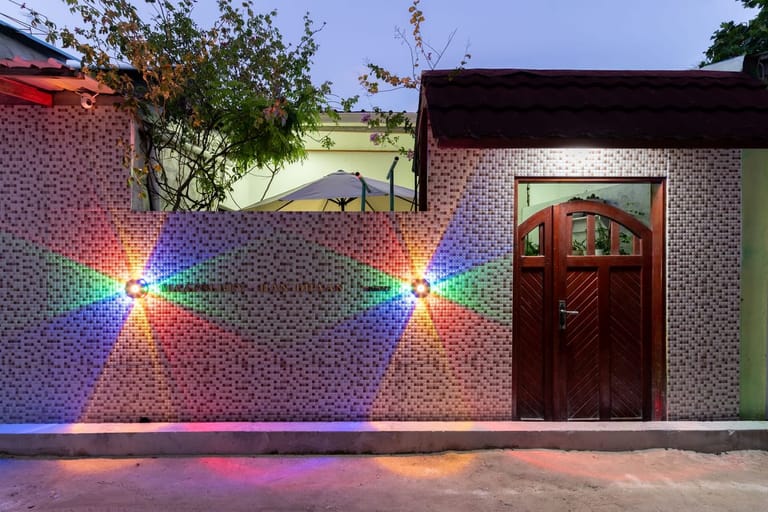 Front entrance of Maafolhey Han'dhaan at night with warm LED lighting