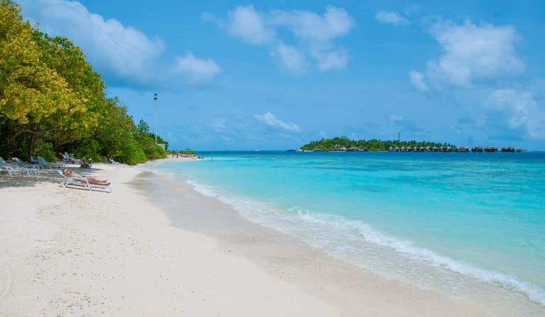 Beach loungers on the white sand of Ukulhas