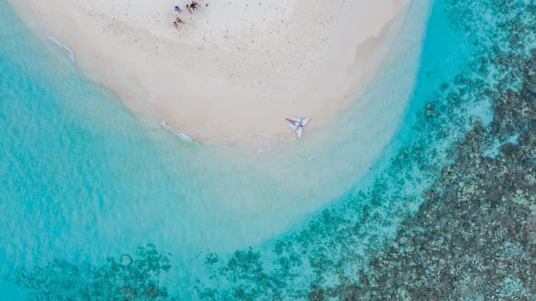 Aerial view of a sandbank ringed by shallow turquoise water near Ukulhas.