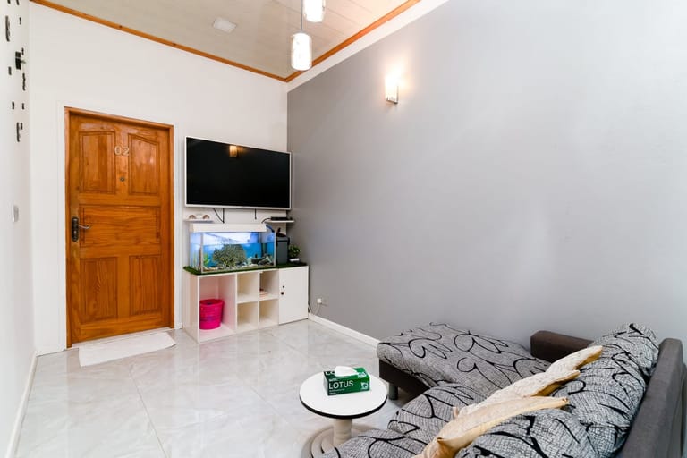 Living room with TV, sofa seating, and the house reef aquarium