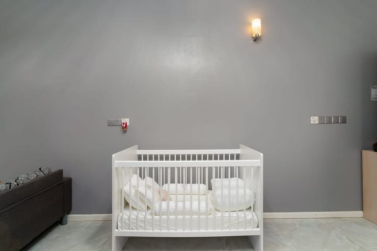 Travel cot set up in the bedroom — available on request at no extra charge